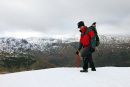 01D-9838 Mountain Walker Decending Rough Edge in Winter with the View to the Eastern Fells Caudale Moor Lake District.