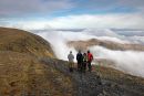 04D-0716 Four Walkers Watching Cloud Spill Over Sharp Edge on the Mountain of Blencathra Lake District Cumbria