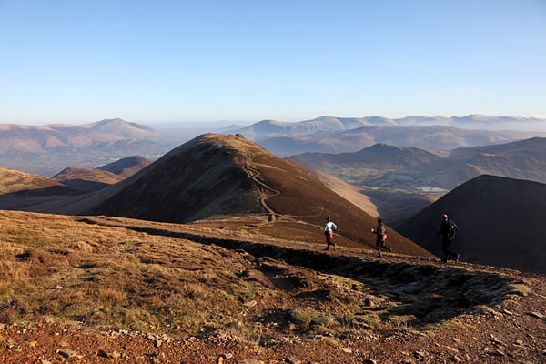 04D-2037 Three Runners and the View NE from the Slopes of Sail Towards the Summit of Causey Pike Blencathra and the Helvellyn Range Lake District Cumbria.