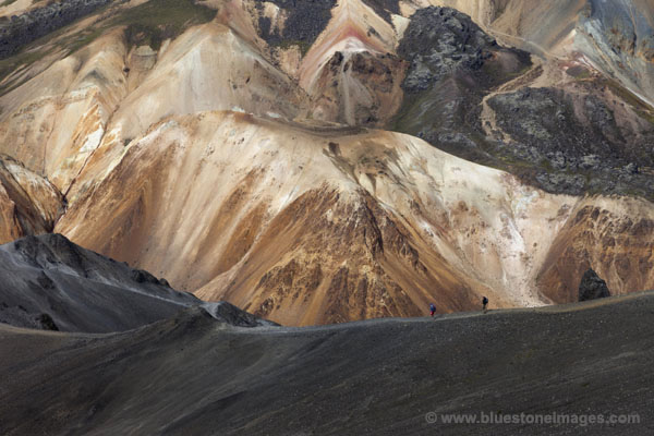 06D-1640 Hikers Decending the West Ridge of Blahnukur with the Colourful Slopes Brennisteinsalda Volcano Behind Landmannalaugar Iceland.