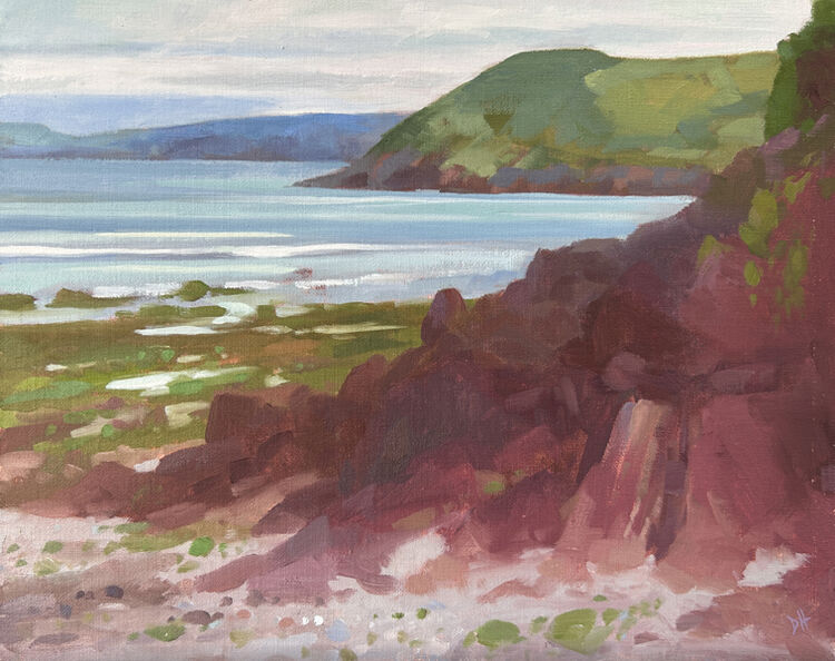 plein air oil painting of the red rocks at manorbier beach in pembrokeshire
