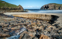STREAM FLOWS TO DALBEG BEACH by Neal Partridge