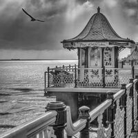 SUN SHINES BEHIND PIER by Tony Barker