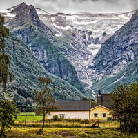 WOOD CLAD HOUSES BENEATH ICEFIELD by Tony Barker