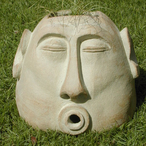 large outdoor sculptural pot of an abstract man's head
