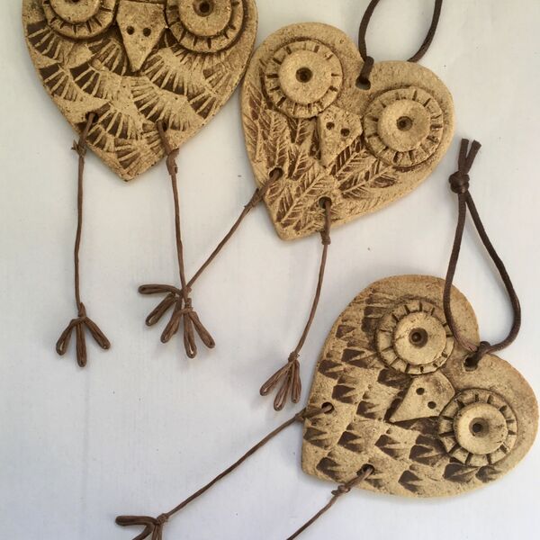Cheeky ceramic owl hangings with moveable legs made by dei ceramics