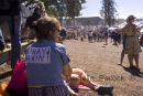 A woman watches the 2007 Paniyiri Greek Festival on the grass of Musgrave Park