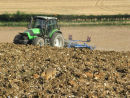 Brown Hare Chasing a Tractor on Farmland