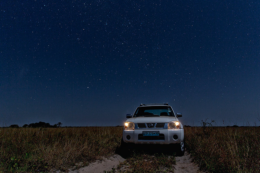 Our 4x4 under a starry night sky in the grasslands of Maputo Special Reserve.