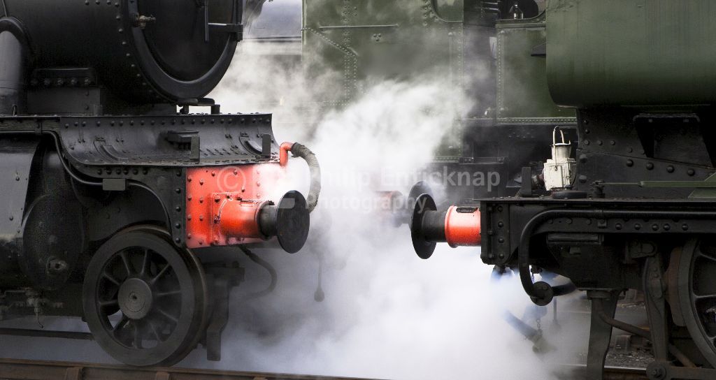 Close up of steam emitting between locomotives