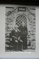 King Charles and his wife pose outside the palace, taken around 1898