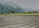 View across ploughed fields to the chapel in the distance
