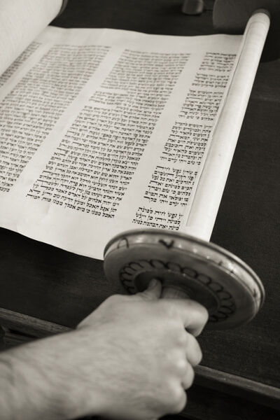 Open Torah scroll showing right-to-left handwritten Hebrew