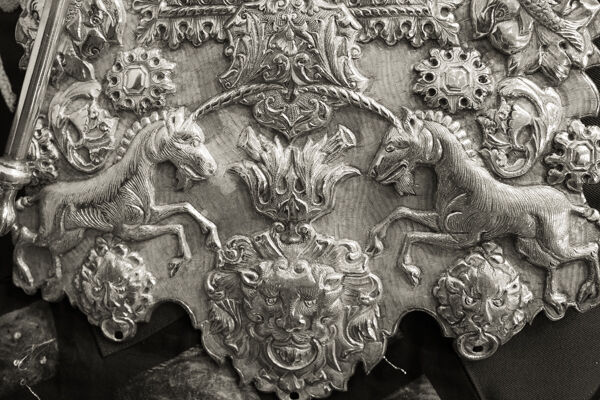 Ornate silver plate around a Torah scroll