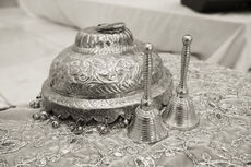 A decorative vessel (kalash) and hand bells (ghanta), used in worship to create a sacred atmosphere and invite divine presence