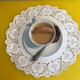 'Art Tea' blue cup with dunked Ginger Nut & tea bag on the side