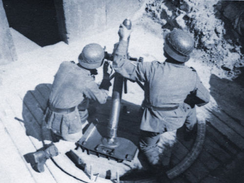 Troops firing a mortar.