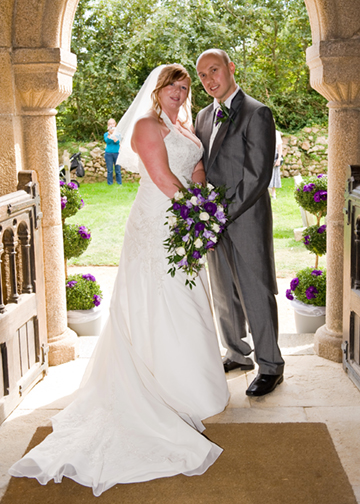 The couple look back into church.