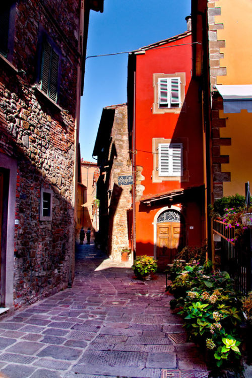 Narrow street captured in sunlight.