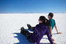 Couple sitting on Salar de Uyuni, Bolivia