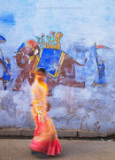 Woman walking past mural, Bundi, Rajasthan, India