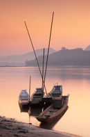 Boats on Mekong River at sunset, Luang Prabang, Laos