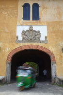 Tuk tuk passing under Old Gate, Galle
