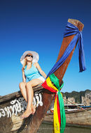 Woman sitting on boat on Railay beach, Thailand