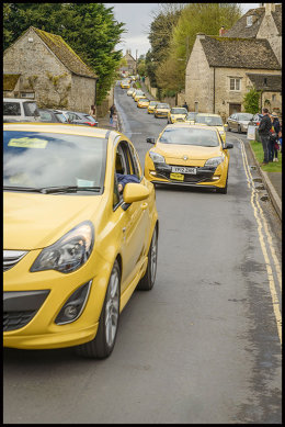 Yellow car convoy in Bibury