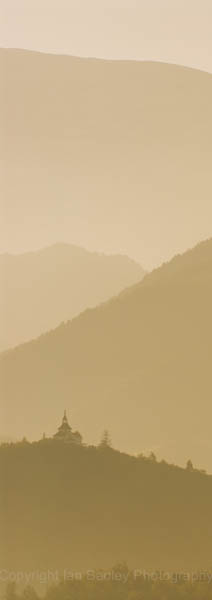 A hill top church on a misty morning in the Pyrenees mountains