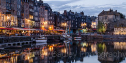 Sailing boats moored at the old port of Honfleur, Normandy, France, at dusk