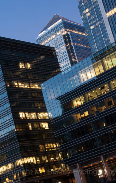 Yellow and blue light of office buildings at twilight, London, England
