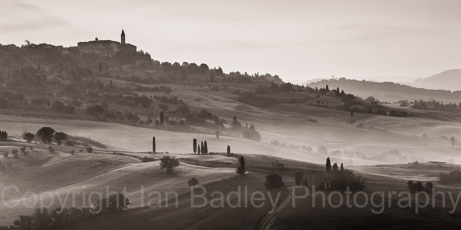 Cypress trees over rolling hills below Pienza, Tuscany, Italy