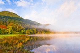 Autumn colours over a misty Loweswater at sunrise, Lake District National Park, Cumbria, England