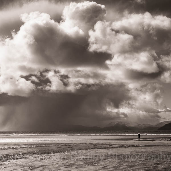 Lone walker on Red Point beach on the north west coast of Scotland
