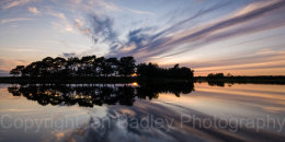 Wierd cloud formation reflections at sunset at Hatchet Pond, Beaulieu, New Forest National Park, Hampshire, England