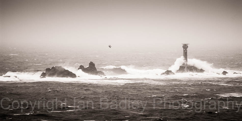 Longship's lighthouse in rough seas off Land's End, Cornwall England