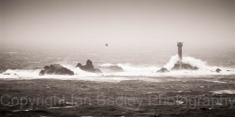 Longship's lighthouse in rough seas off Land's End, Cornwall England