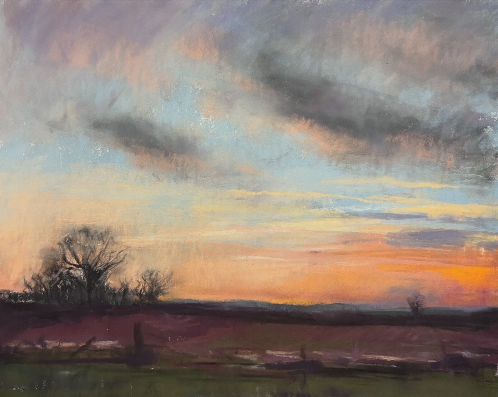 View over the fields of Frostenden, Suffolk with a golden sunset and fluffy clouds