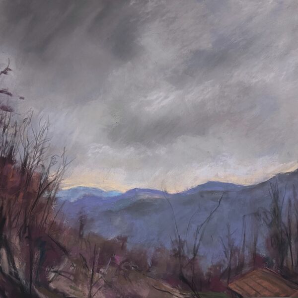 View along the Belbo Valley near Mombarcaro Italy.  With dark clouds and distant blue and purple hills