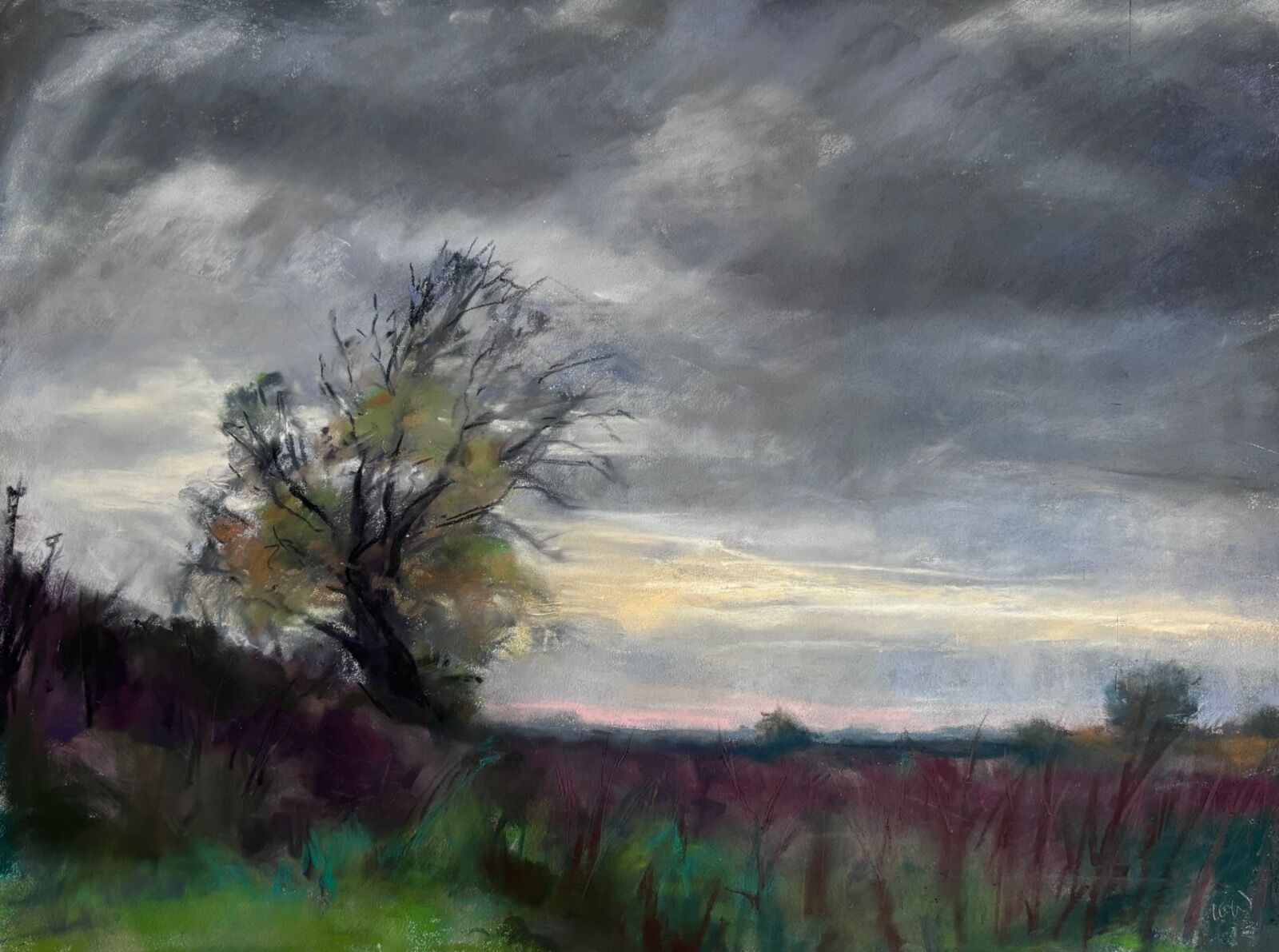 Suffolk landscape with dark clouds and windswept trees in the late afternoon Autumn 2025