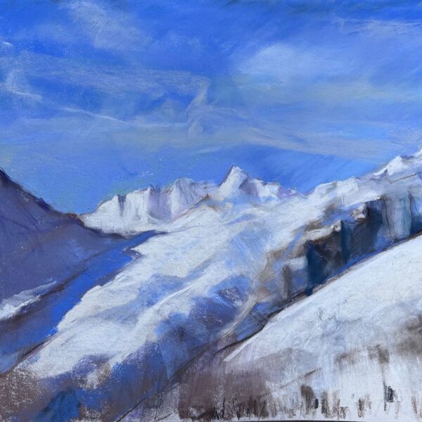 View storm the top of the lift looking towards Breithorn with lots of blue skies trees and snow covered mountains