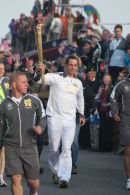Ben Ainslie with the Olympic Torch at Land's End
