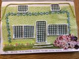Depiction of Home in fabric and buttons