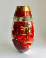 Red smoke-fired pot with gold lustre.