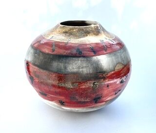 Red smoke-fired pot with gold lustre.