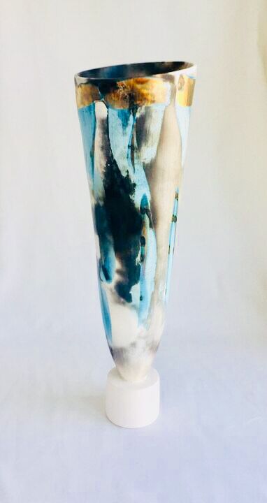 Large blue smoke-fired pot on stand with gold lustre.