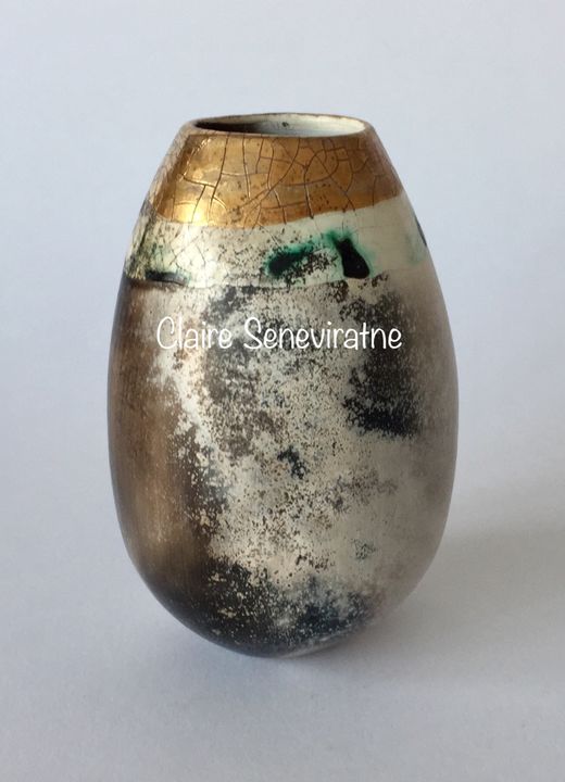 Smoke fired pot with gold lustre.