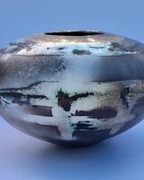 Smoke-fired porcelain pot with gold lustre.