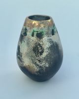 Small upright smoke-fired ceramic pot.